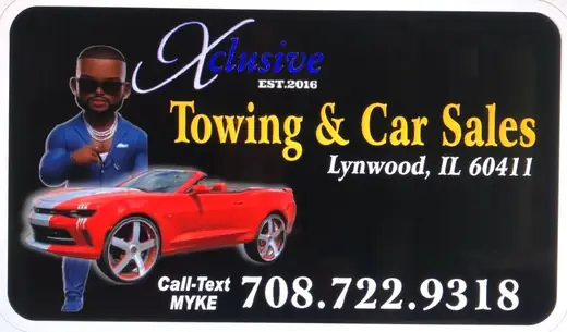 Towing and car sales sign with a red sports car graphic
