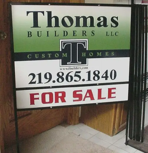 For-sale yard sign for a custom home builder