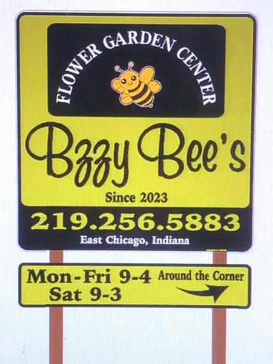 Garden center sign with store hours on a post